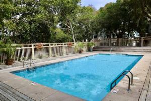 a swimming pool with blue water in a yard at Marsh Mellow in Southport