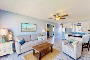 a living room with a couch and a table at Saltwater Kure in Kure Beach +42 photos