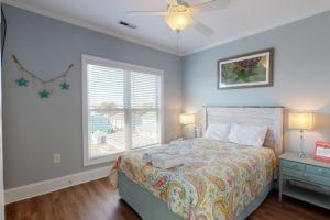 um quarto com uma cama e uma janela em Carolina Beachside em Carolina Beach