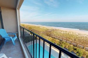 a balcony with a view of the beach at Paradise Found in Carolina Beach
