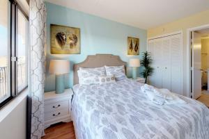 a bedroom with a bed with two stuffed animals on it at Paradise Found in Carolina Beach
