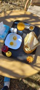 a tray with eggs and other food on a table at Grapes Garden Resort Hunza in Hunza Valley