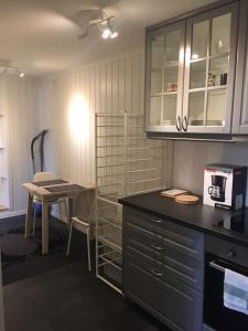 a kitchen with a table and a counter top at Leilighet 1 og 2 - Mandal, Norges sørligste kommune in Ime