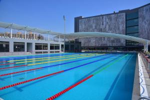 a large swimming pool in a large building at Ibiza Hotel in Ahmedabad