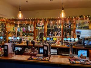 a bar with a lot of liquor bottles at Vale of York restaurant and rooms in Thirsk