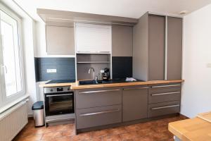 a kitchen with a sink and a stove at Bleu des Vosges in Gérardmer