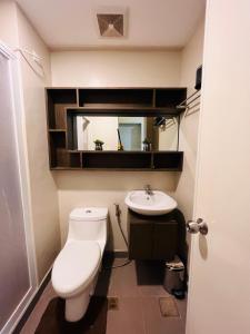 a bathroom with a toilet and a sink at * *R Metropolitan Mirage in Iloilo City +6 photos