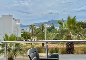 a balcony with a view of a street and palm trees at Deniz Manzaralı, Plaja 100 Metre, Luks Daire 3 in Marmaris