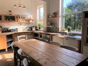 a large kitchen with a wooden table and chairs at Winter Escape with heated pool in Roby