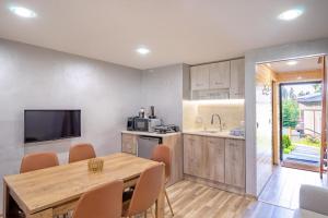 a kitchen and dining room with a wooden table and chairs at Boro Green Holiday Village in Borovets