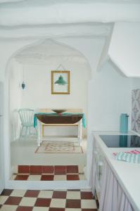a dining room with a table and a checkered floor at Casa Mosaico Granada en el V de Lecrin in Nigüelas