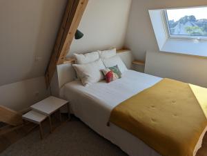 Habitación pequeña con cama y ventana en La Maison d'Enfance en Heimsbrunn