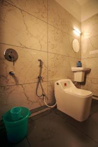a bathroom with a shower and a toilet and a sink at Redstone Villa in Tāzhekkod +17 photos