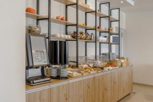 a bakery counter with pastries and other food items at Areti Hotel in Agia Galini