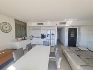 a living room with a large couch and a kitchen at Top-Luxury Exclusive Аpt with Jacuzzi in front of the sea in Eilat