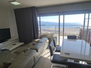 a living room with couches and a view of the ocean at Top-Luxury Exclusive Аpt with Jacuzzi in front of the sea in Eilat