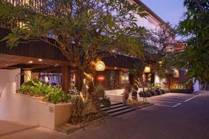 a store front with trees and plants in front of it at The Bene Hotel in Kuta