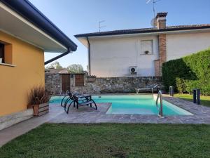 a swimming pool in the backyard of a house at Siore Marie gli alloggi in San Giorgio di Nogaro