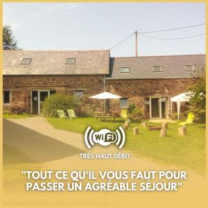 a building with a sign in front of it at Le Jardin Enchanteur, chaleureuse maison d'hôtes éco-responsable, calme et accueillante in Lopérec