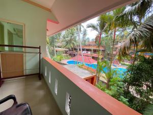 a balcony with a view of a swimming pool at Packbag Comfort Bed & Breakfast in Kovalam