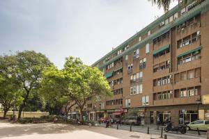 a large brick building on a city street at Macflats Ciudad de las Ciencias in Valencia