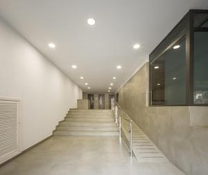 a staircase in a building with white walls and ceilings at Macflats Ciudad de las Ciencias in Valencia