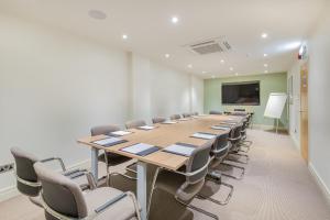 a conference room with a long table and chairs at The Riverside in Kendal
