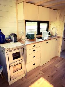 a kitchen with white cabinets and a stove top oven at Zum Wilden Michel in Oberlinach