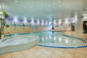 a large swimming pool with a large tub at The Riverside in Kendal