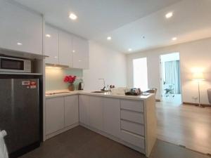 a kitchen with white cabinets and a counter top at RM201 Bukit Bintang 2 Bedroom Balcony CIty View in Kuala Lumpur