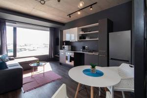 a living room with a white table and a kitchen at Modern Studio in Wex1 538 in Cape Town