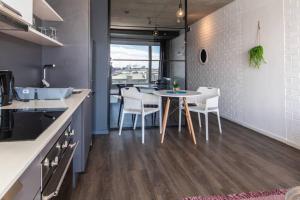 a kitchen and dining room with a table and chairs at Modern Studio in Wex1 538 in Cape Town