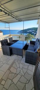 a patio with couches and a table on a roof at Apartments Marijana in Zavalatica
