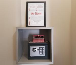 a display of a microwave with a picture on the wall at B&B Monté in Montesilvano +41 photos
