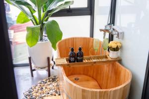 a wooden barrel with two bottles in it next to a plant at Entireplace*2Br/Bathtub/SuperCenter*New* in Hanoi