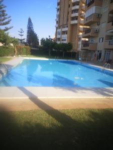 a large blue swimming pool in front of a building at Concordia in Roquetas de Mar