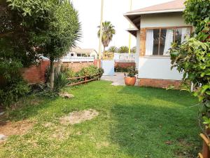 ein Hof eines Hauses mit einem Garten voller Gras in der Unterkunft Japie's Yard Self-Catering in Swakopmund