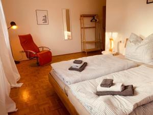 a bedroom with two beds with towels on them at Adlerhorst in Thyrnau