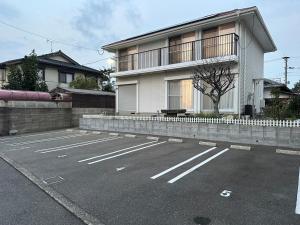 an empty parking lot in front of a house at Prime 糸島 in Itoshima
