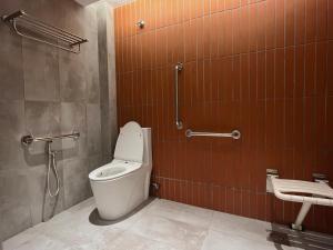 a bathroom with a toilet and a sink in it at Urban Living Residence in Kuala Lumpur