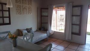 a living room with a couch and a window at Casitas de Campo in Mina Clavero