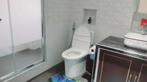 a small bathroom with a toilet and a sink at Avana Hills Boracay Prime Horizon Suite 103 in Boracay +75 photos