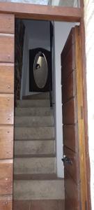 a stairway with a round mirror and a staircase at Camera Vacanze Lusitana C in Foligno