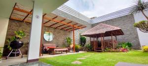 a patio with a grill and a gazebo at Rumah Oma Lembang for Family & Friends in Lembang