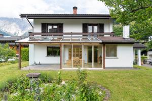 a house with a solarium on the front of it at Ferienhaus Linde in Bartholomäberg