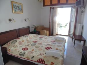 a bedroom with a bed in a room with a window at Maria Studios in Skiathos