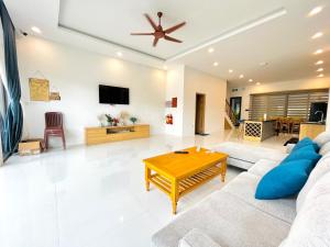 a living room with a couch and a table at Lucee villa Phu Quoc in Phu Quoc