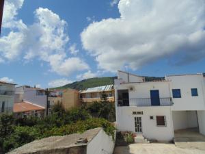 a group of buildings in a town with a cloudy sky at Maria Studios in Skiathos