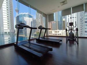 a gym with three exercise bikes and a large window at RM231 2Bedroom Bukit Bintang Balcony KL City View in Kuala Lumpur