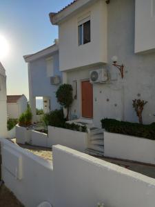 a white house with a white fence in front of it at Siviri kassandras Xalkidiki, Experience Accomodation in Siviri